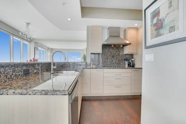 a kitchen with stainless steel appliances granite countertop a sink and cabinets