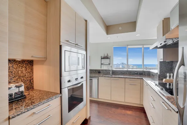 a kitchen with stainless steel appliances granite countertop a stove sink and cabinets