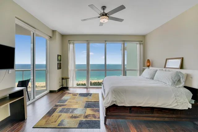 a bedroom with a large bed and a large window