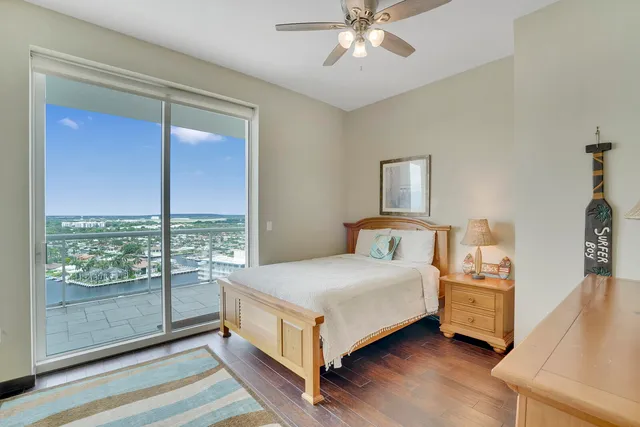 a bedroom with a bed and large window