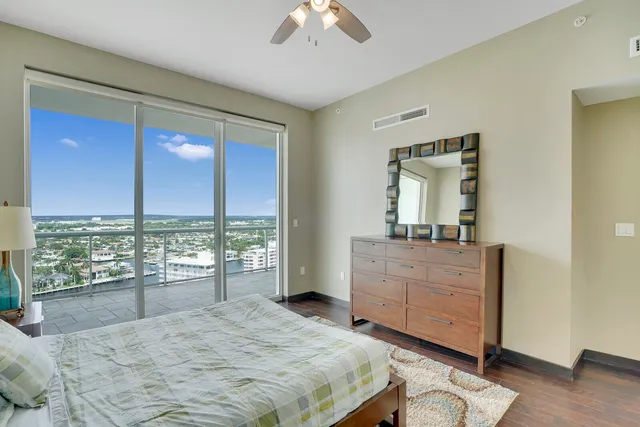 a bedroom with a large bed and a large window