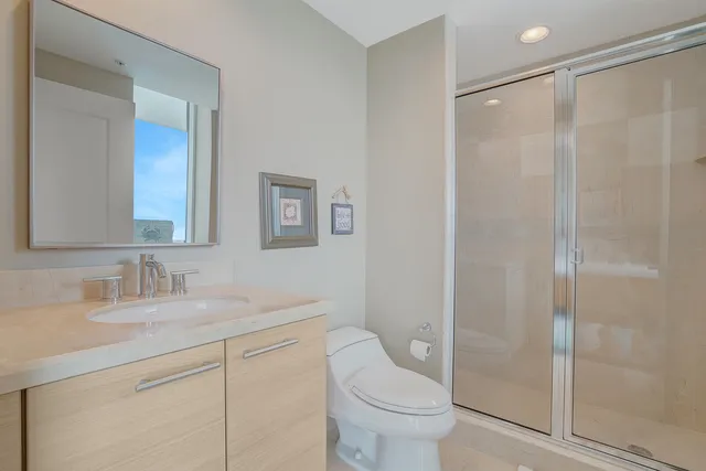 a bathroom with a sink toilet and shower