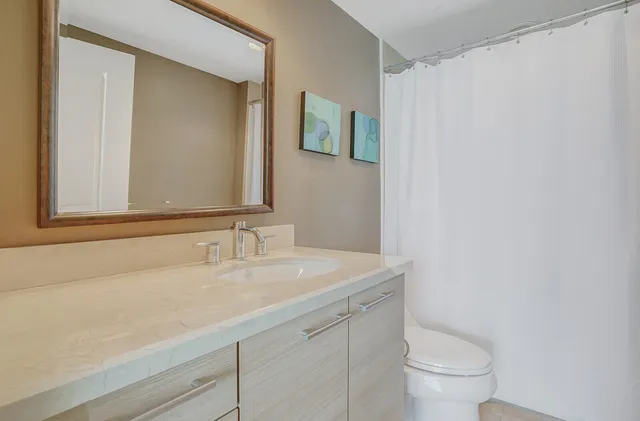 a bathroom with a sink a toilet and mirror