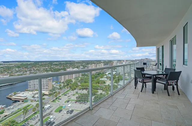a view of a chairs and table in the balcony
