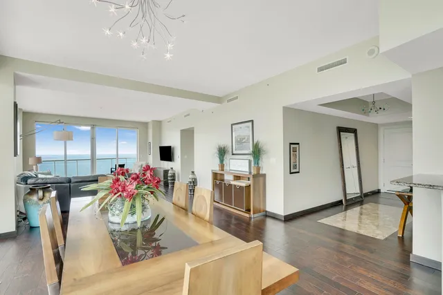 a dining room with furniture and wooden floor