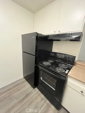 a kitchen with a stove and a microwave