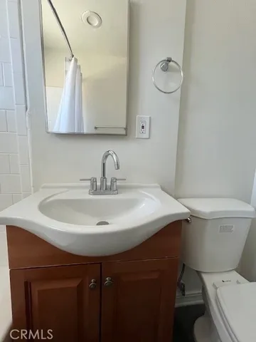 a bathroom with a sink toilet and mirror