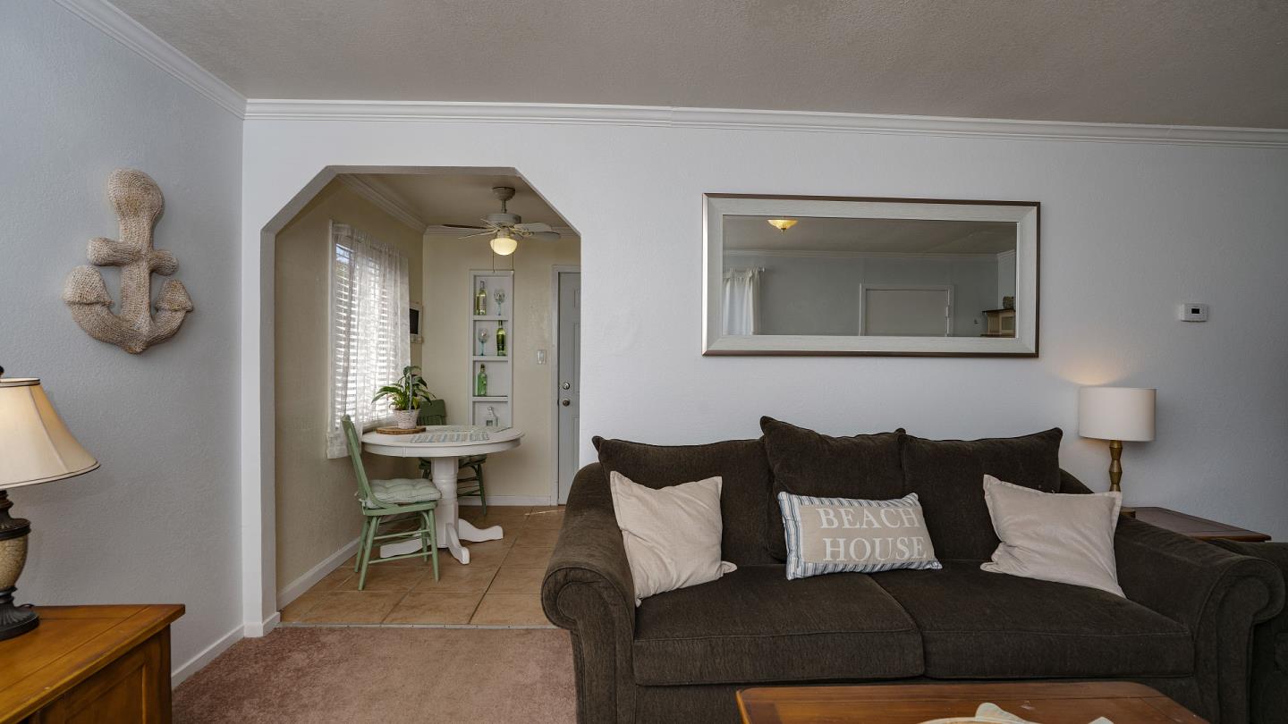 255 Brighton Road Pacifica, CA 94044 - Photo 8 of 29 a living room with furniture and a mirror