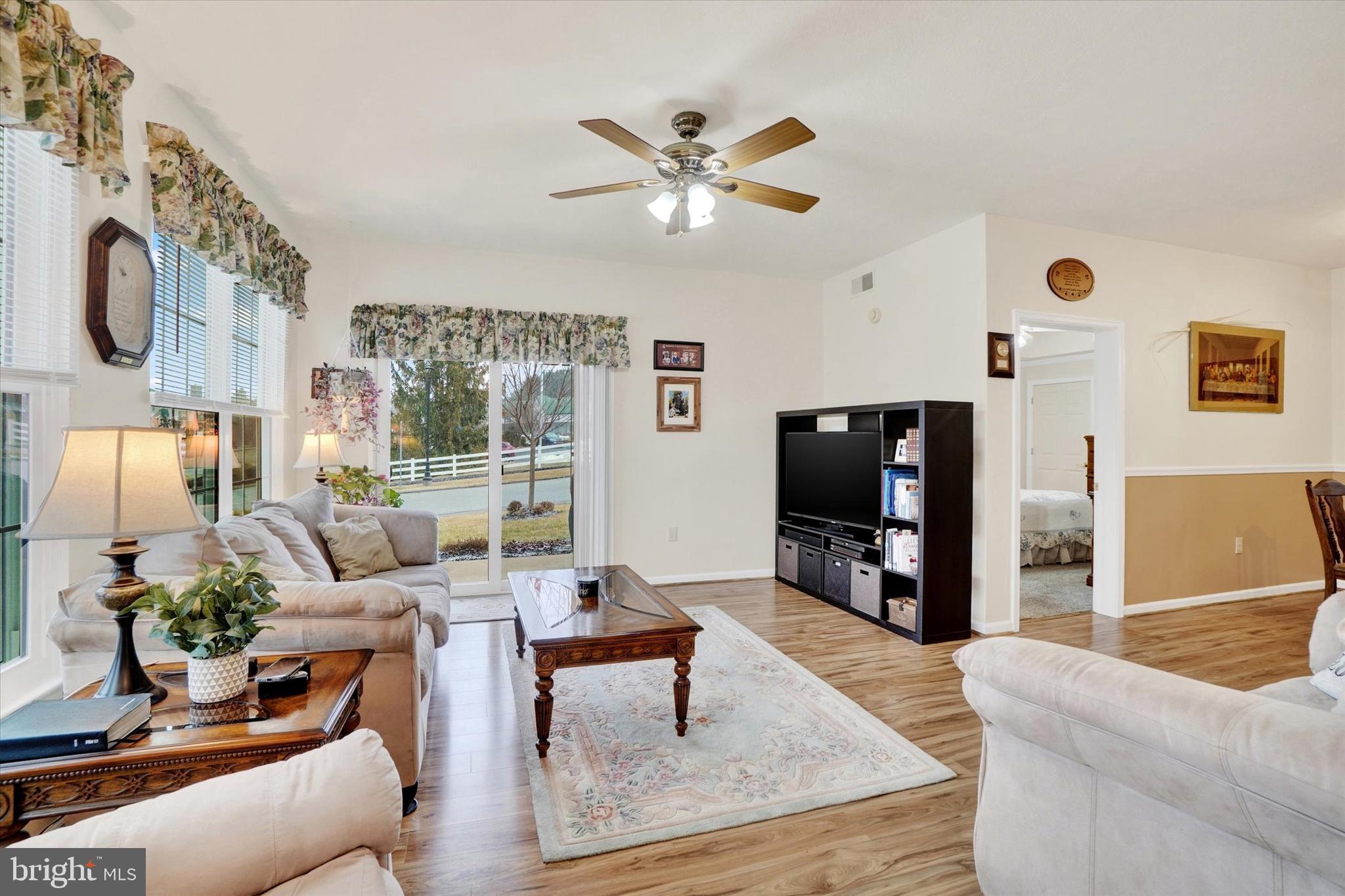 102 Marshview Road, Unit 102 Stewartstown, PA 17363 - Photo 4 of 25 With a new slider and Pergo flooring.