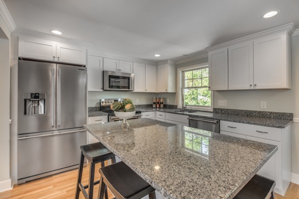 10 Janet Road Arlington, MA 02474 - Photo 14 of 26 a kitchen with a refrigerator a microwave a sink and cabinets