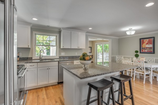 10 Janet Road Arlington, MA 02474 - Photo 15 of 26 a kitchen with stainless steel appliances granite countertop table chairs sink and cabinets