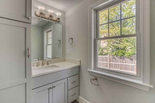 10 Janet Road Arlington, MA 02474 - Photo 19 of 26 a bathroom with a sink vanity and a mirror