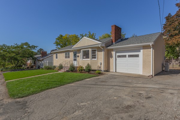 10 Janet Road Arlington, MA 02474 - Photo 3 of 26 a front view of a house with a yard and garage