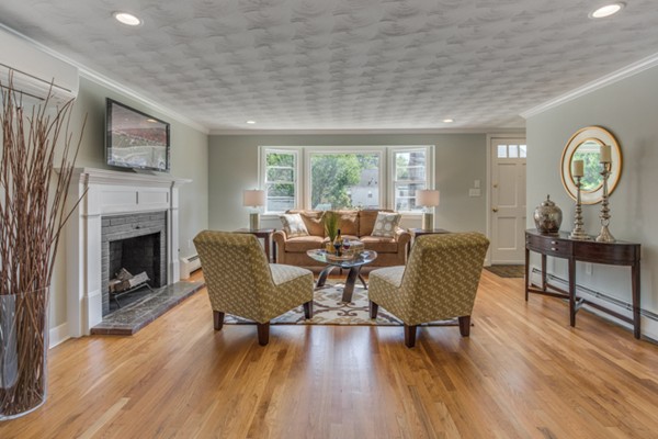 10 Janet Road Arlington, MA 02474 - Photo 7 of 26 a living room with furniture a fireplace and a table