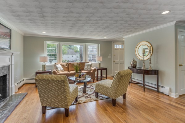 10 Janet Road Arlington, MA 02474 - Photo 8 of 26 a living room with furniture a fireplace and a large window