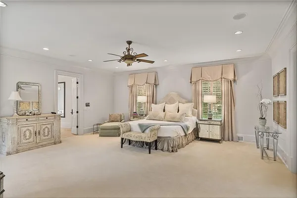 a living room with furniture a chandelier and a fireplace
