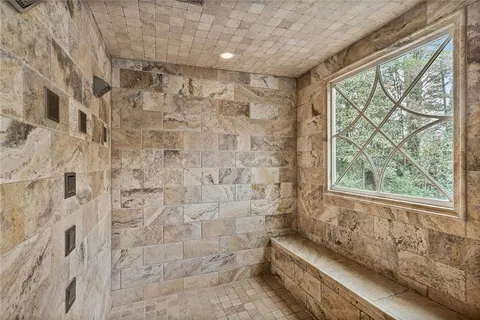 a view of walk in closet with clothes shoes and a chandelier