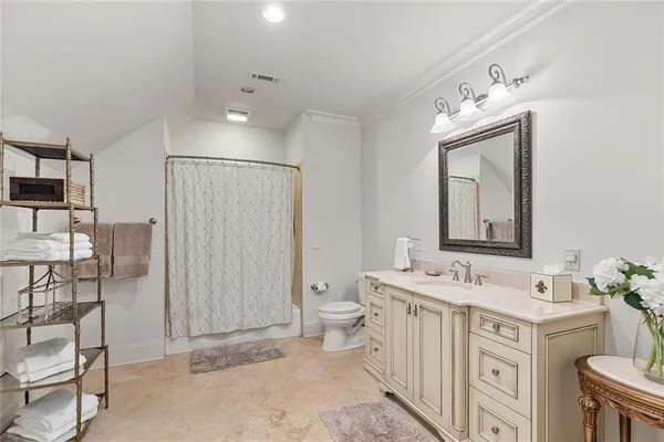 a spacious bedroom with a bed and a ceiling fan
