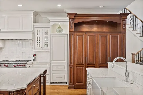 a kitchen with stainless steel appliances granite countertop a stove and a refrigerator