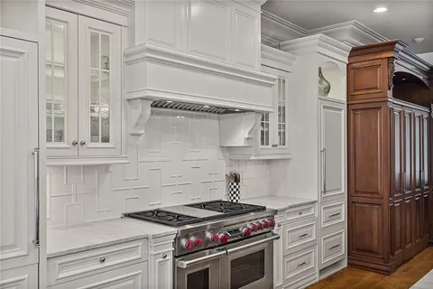 a large kitchen with stainless steel appliances lots of counter space and wooden floor