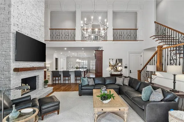 a living room with furniture and a chandelier