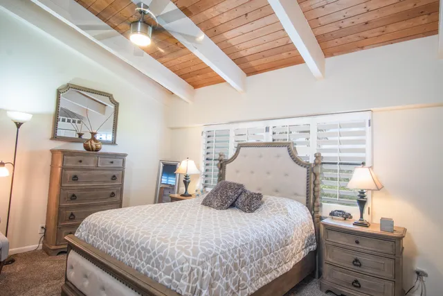 a bedroom with a bed and flat screen tv