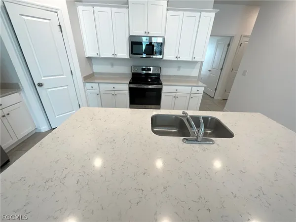 a kitchen with a sink a stove and refrigerator