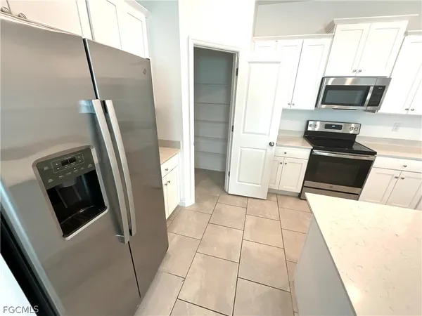 a kitchen with stainless steel appliances a refrigerator microwave and sink