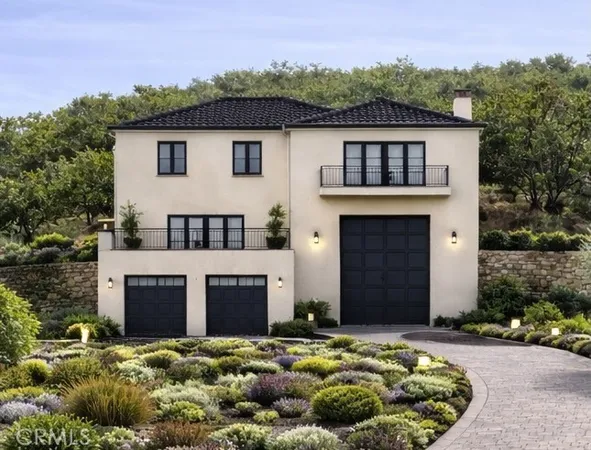 a front view of a house with a garden