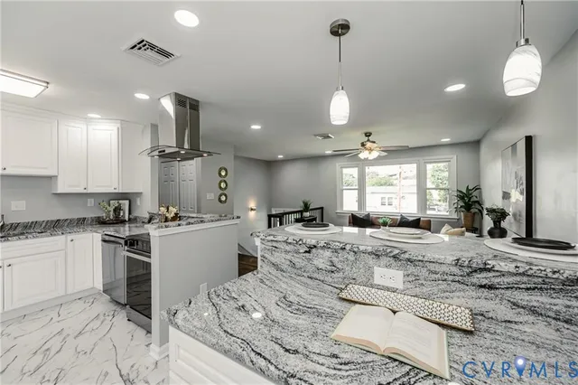 a large kitchen with kitchen island a stove a sink a center island a stove a cabinets and a dining table