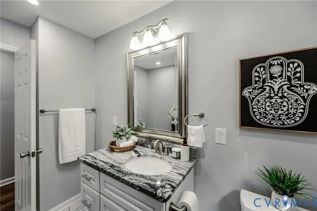 a bathroom with double vanity sinks and a mirror