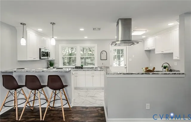 a kitchen with stainless steel appliances granite countertop a sink and a refrigerator