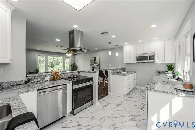 a kitchen with stainless steel appliances granite countertop a sink a stove and cabinets