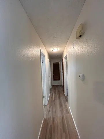 a view of hallway with wooden floor