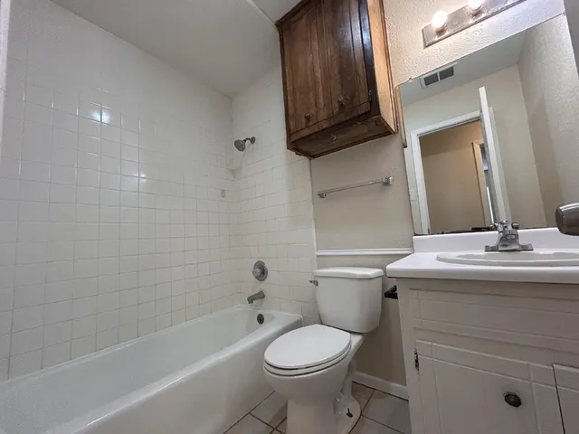a bathroom with a sink a toilet and bathtub