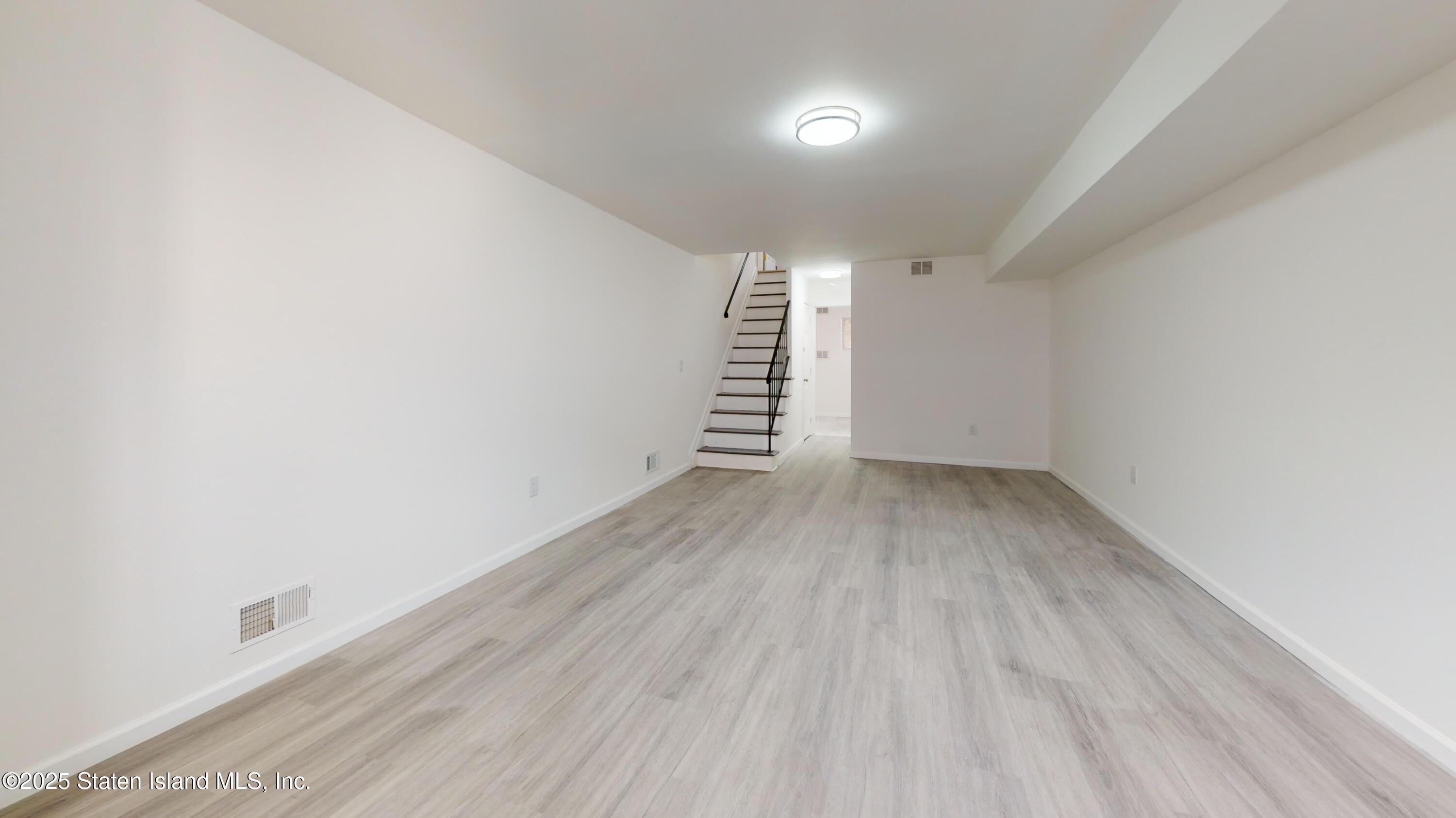 109 Lyceum Court Staten Island, NY 10310 - Photo 11 of 32 a view of room with stairs and a window