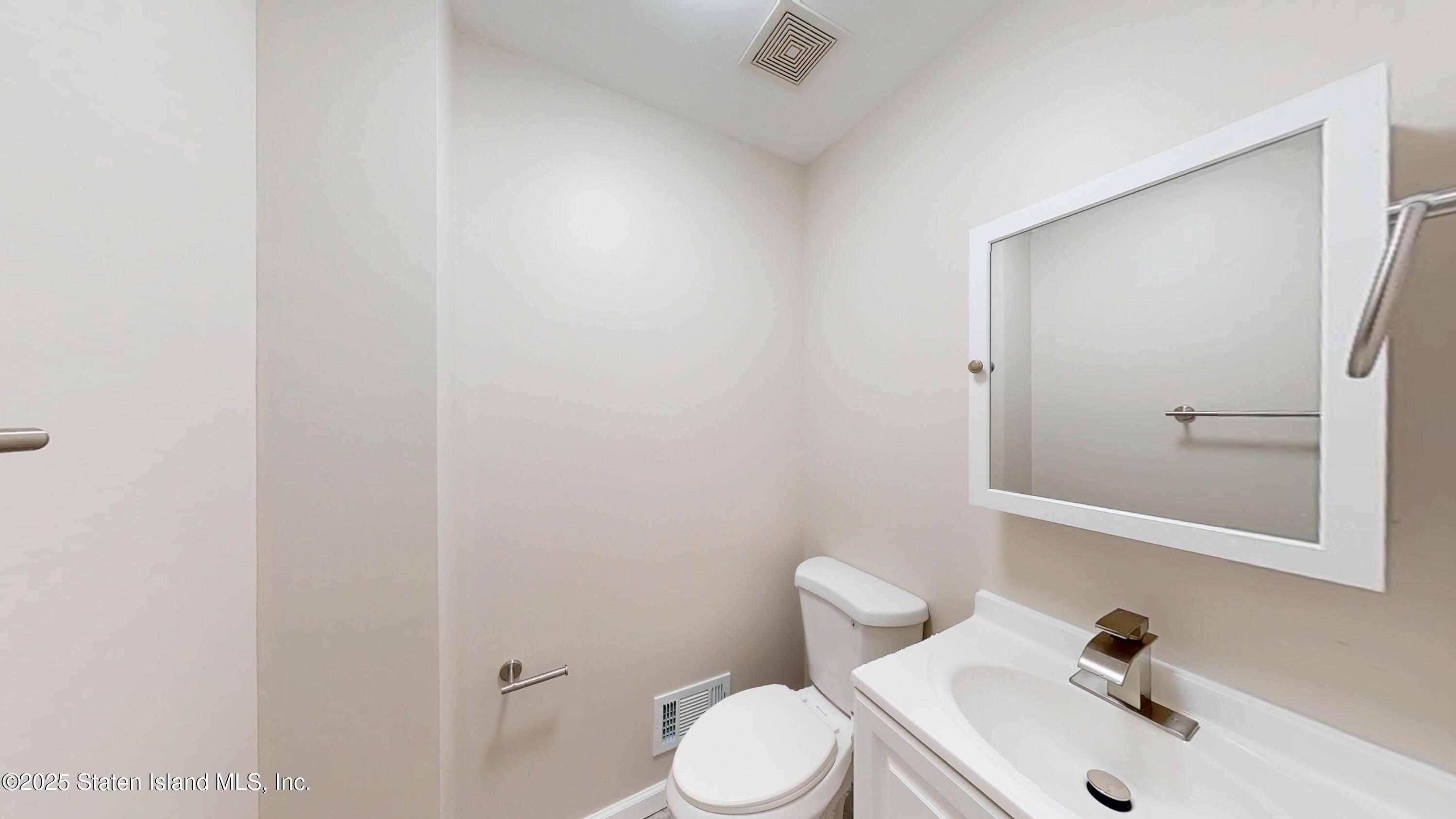 109 Lyceum Court Staten Island, NY 10310 - Photo 16 of 32 a white toilet sitting next to a bathroom sink