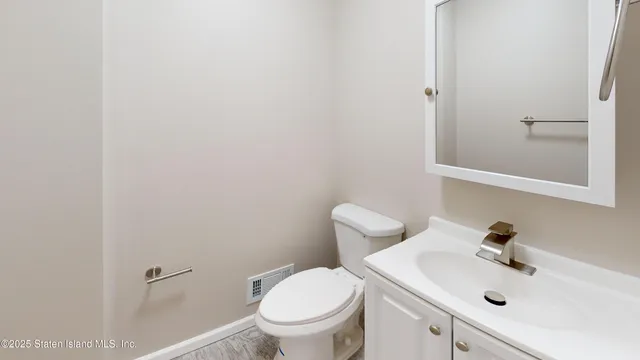 a white toilet sitting next to a bathroom sink
