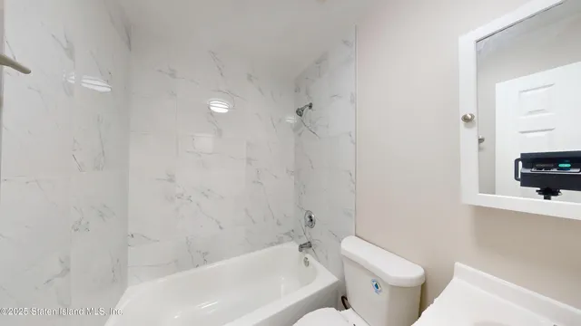 a bathroom with a bathtub and toilet