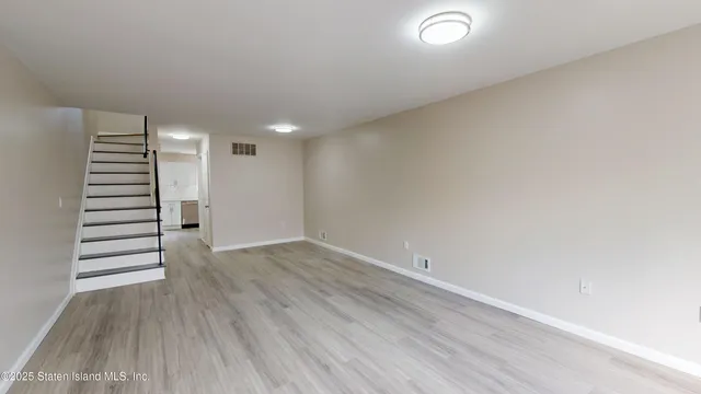 wooden floor in an empty room with stairs