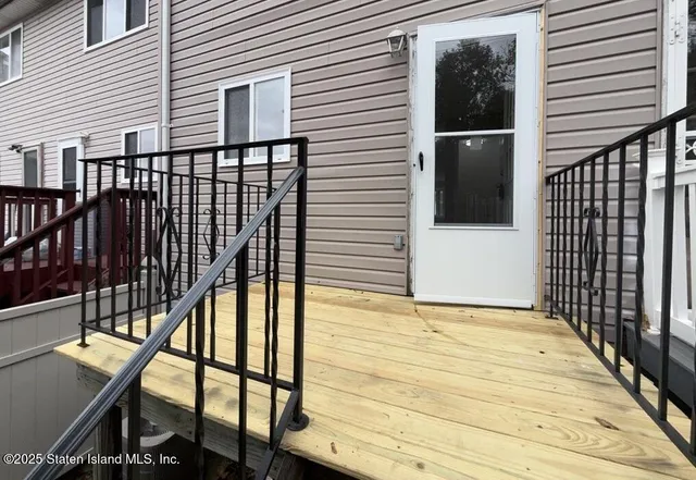 a view of balcony with wooden floor