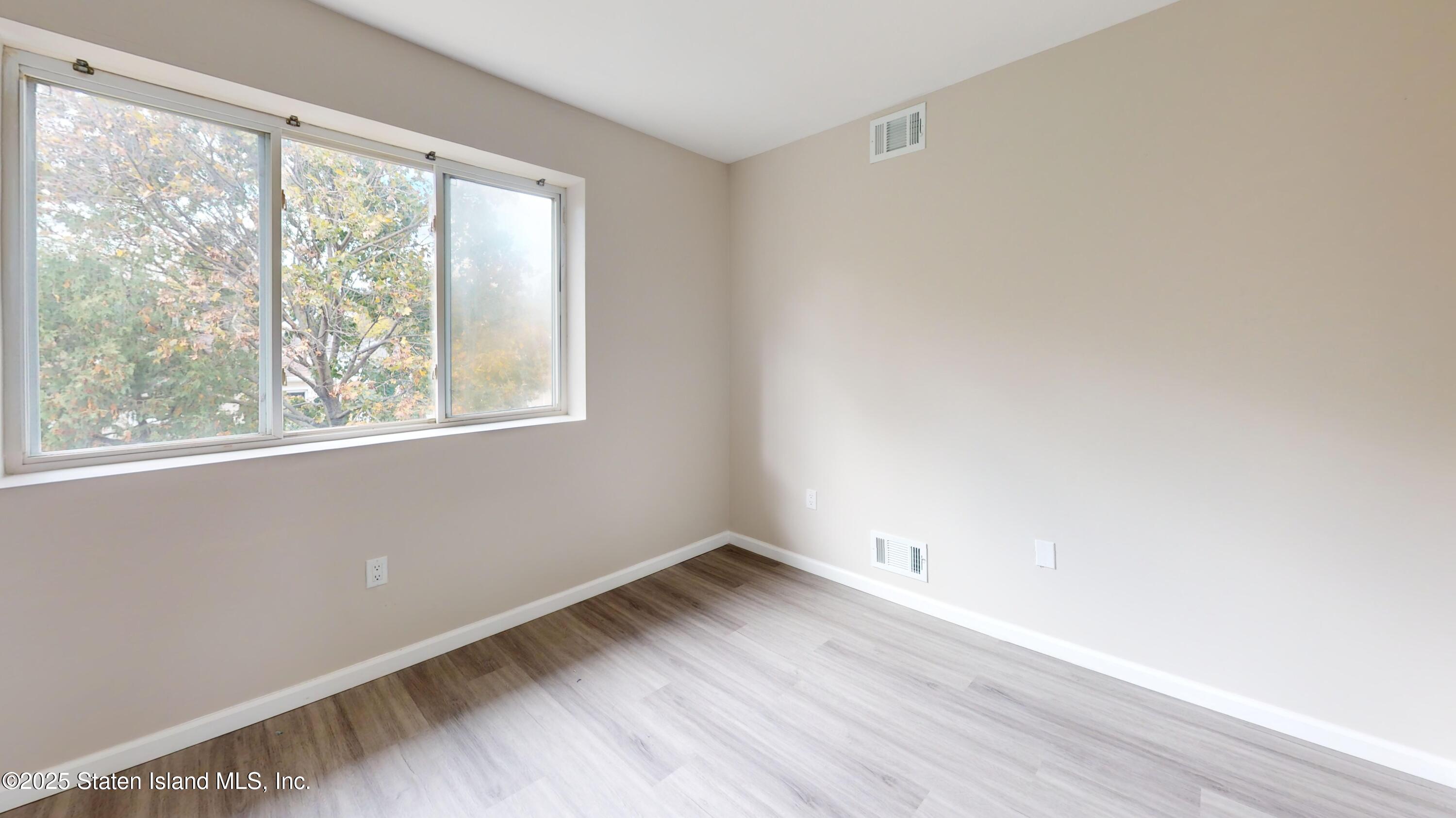 109 Lyceum Court Staten Island, NY 10310 - Photo 6 of 32 a view of a room with wooden floor and windows