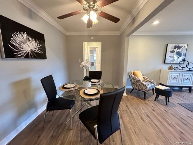 475 Little E Neck Road, Unit L467 West Babylon, NY 11704 - Photo 3 of 6 a view of a dining room with furniture and wooden floor