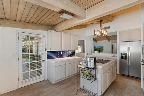 a kitchen with kitchen island granite countertop a sink cabinets and stainless steel appliances