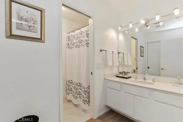 a bathroom with a sink vanity and a mirror