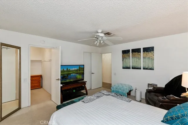 a bedroom with a bed and a television