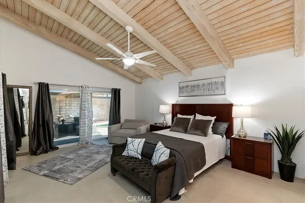 a bedroom with furniture and a large window