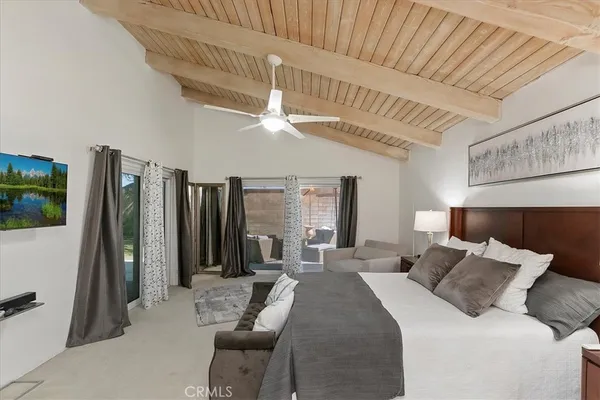 a bed room with a bed and a television