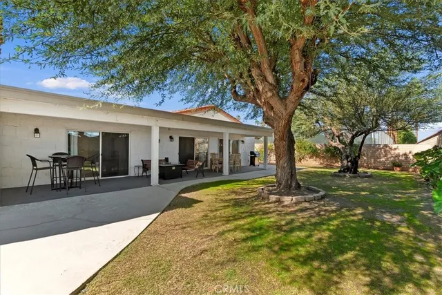 a view of a house with backyard porch and sitting area