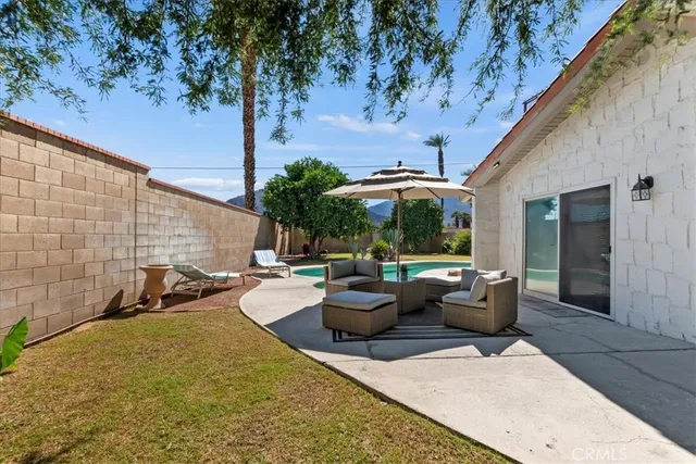 a view of swimming pool with outdoor seating and barbeque oven